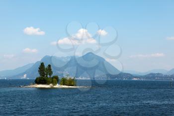 Charming little island in Lake Maggiore, photographed with a tourist pleasure boat

