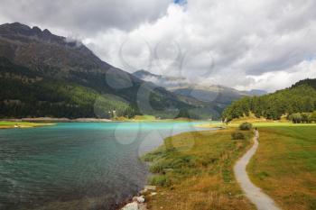 The picturesque lake in the Swiss Alps. Path along the shore