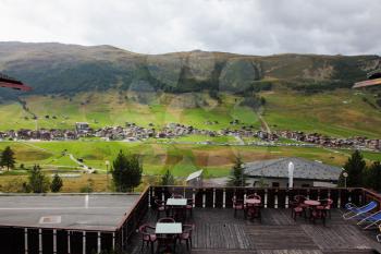 A popular mountain resort in the Alps. The beginning of autumn. The view from the terrace of a prestigious ski hotel