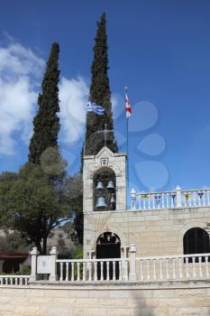 The bell tower, topped by a cross, a Christian church in Jerusalem.
