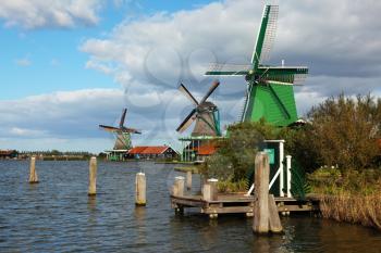 Ancient windmills and channels in museum ethnographic small town in Holland