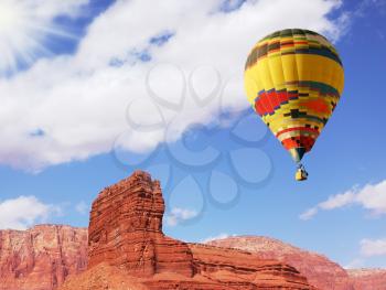 Bright beautiful balloon over double Sphinx of red sandstone. The valley of the Colorado River