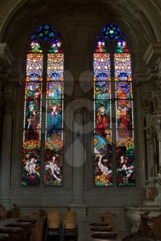  Bright multi-colour stained-glass windows in an ancient cathedral in Switzerland    