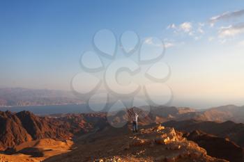 Classical bible landscape - desert Sinai in a morning fog and the lonely tourist