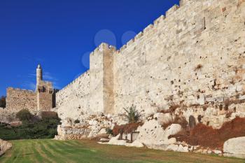 Walls of eternal Jerusalem. The sunset softly shines ancient walls and David's Tower
