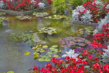  A pond and a flower bed in fine park in Canada