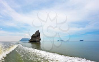 Boat trip in the Gulf of Thailand. The picturesque island-rock float in a sea mist