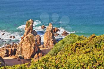 Picturesque rocks on a lonely beach of Atlantic ocean. Coast of Portugal, Cabo da Roca - the most western point of Europe
