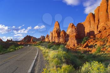 Road among freakish natural stone formations in the well-known park Arches in the USA 