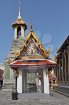 The overgilded and ornated tower with a bell in a royal palace in Bangkok
