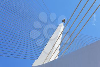 The new ultra-modern white bridge in Jerusalem. Strings suspension bridge and snow-reliance against the blue sky