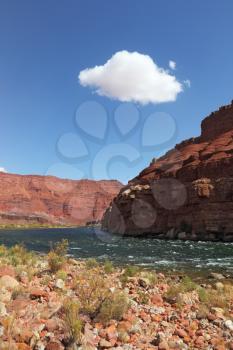 The majestic cliffs of red sandstone and rapids of the Colorado River.