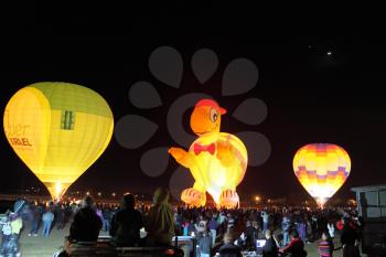 Three huge balloons. Happening glowing balloons in the night sky