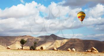 Magnificent transparent day in Judean desert. Bright beautiful balloon over soft hills