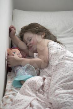  The little girl strong sleeps, embracing a doll