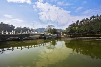 The big pool with quiet water and the bridge near to hotel in the Chinese city