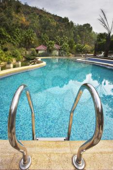 Pool with pure transparent water and hand-rail of descent
