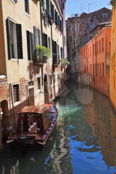 Gorgeous Venice. The narrow street channel. Scenic gondola with gazebo