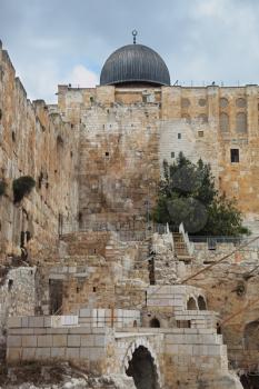 Walls of eternal Jerusalem and a dome of a Muslim mosque
