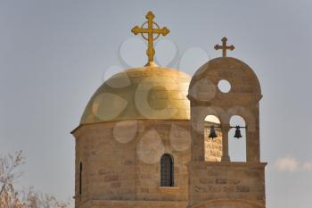  The dome of orthodox church shined by the sun and a small belltower near to it