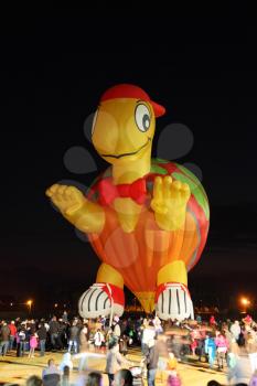A huge balloon in the form of Teenage Mutant Ninja Turtles. Happening glowing balloons in the night sky