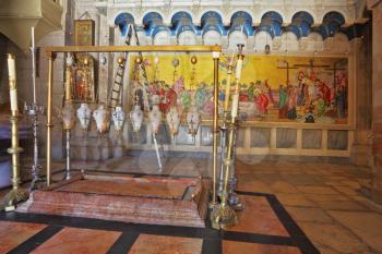 Temple of the Holy Sepulcher in Jerusalem. The oldest Christian sanctuary - Stone of Unction. Fire burns in eight inextinguishable lamp