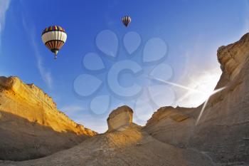 Huge balloons above ancient mountains of the Dead Sea. A sunset 