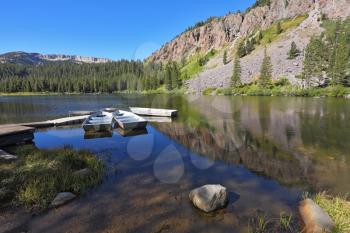 Small boats made of white metal on a quiet mountain Mammoth lake