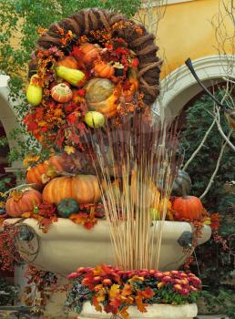 Beautifully decorated lobby luxury hotel. Celebration of harvest: baskets and vases with colorful gourds, flowers and autumn leaves
