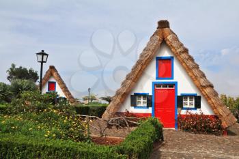 Pastoral landscape. Two charming rural houses with triangular thatched roof. Madeira, the city of Santana