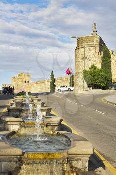
Highway and fountain at walls of ancient city Toledo in Spain
