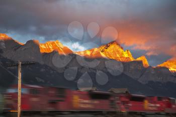 Freight train going with the big speed in winter mountains