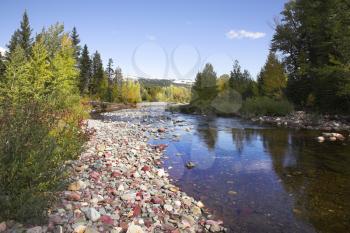 Shallow slow stream with a fine pebble in glacial reserve in Canada