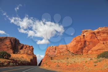 Magnificent American road among rocks of red sandstone