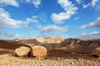 Gorgeous clear day in the Judean desert. Huge stones along the roads, clear skies
