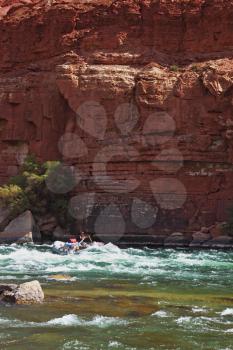 Sporting a young woman on a kayak overcome rapid course of the Colorado River