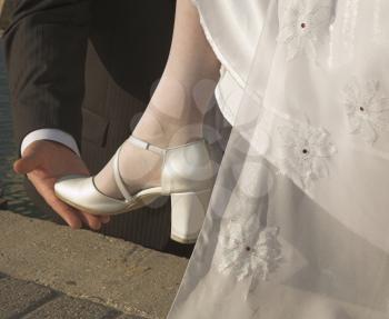  The graceful leg of the bride is supported with a hand of the groom