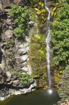 Amazingly beautiful falls with greenish water in a granite channel of a mountain stream