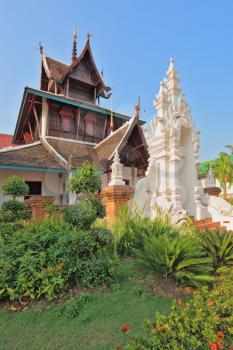 Magnificently decorated entrance to the temple in the north of Thailand. The temple is surrounded with fine tropical park
