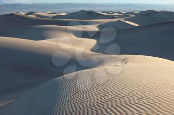 The famous Death Valley in California. Sand dunes are spectacular gold sunrise
