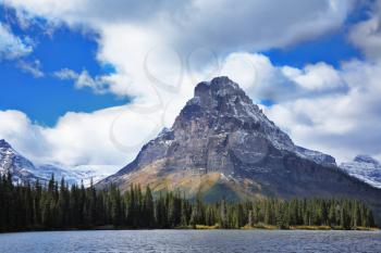 Triangular mountain, forest and the big cold lake in Canada