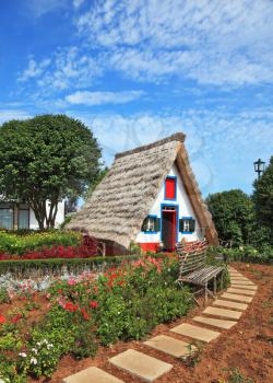 Picturesque house-museum of the first colonists to Madeira. Charming white cottage with a thatched roof and gable small garden with flowers
