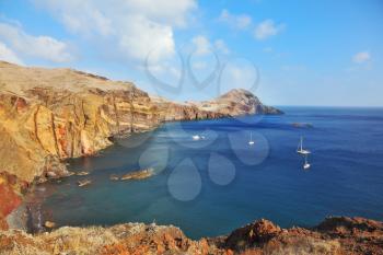 Madeira. Picturesque white yachts in the rocky gulf in the east of the island