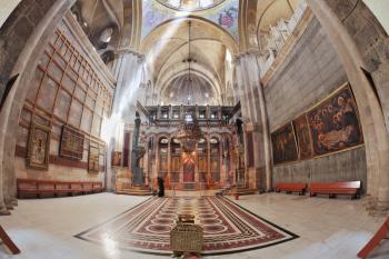 Church of the Holy Sepulcher in Jerusalem. Huge beautifully decorated hall in front of the Edicule. Hall is beautifully lit sunlight through windows in the domed ceiling and lamps. The picture was tak