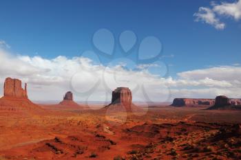The majestic Monument Valley. Tourist white jeep on the road between the cliffs of sandstone Mittens