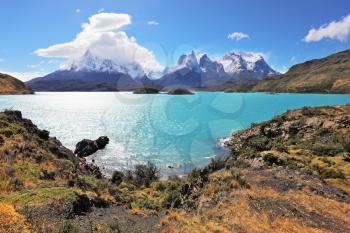 Magic turquoise lake Pehoe national park Torres del Paine, Chile. Majestic rocks Los Kuernos on the bank of the lake are covered with glaciers