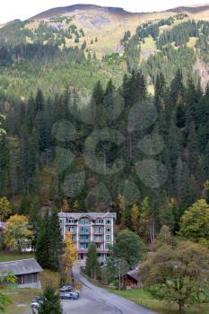  Ancient hotel in the Alpes, surrounded by pines
