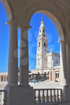 The grand memorial and religious complex in the small Portuguese town of Fatima. A huge tower, topped by a cross and a marble colonnade around the square