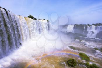 The most high-water waterfall in the world - Iguazu. White whipped foam of water and a thin mist over the water. The Brazilian side. Photo taken by lens Fisheye
