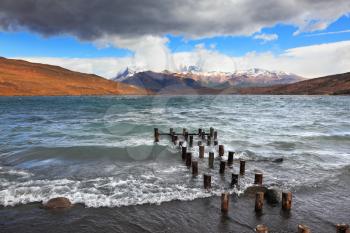 Boat dock on the lake. Storm clouds, wind and waves at the Laguna Azul. National Park Torres del Paine in Patagonia, Chile
